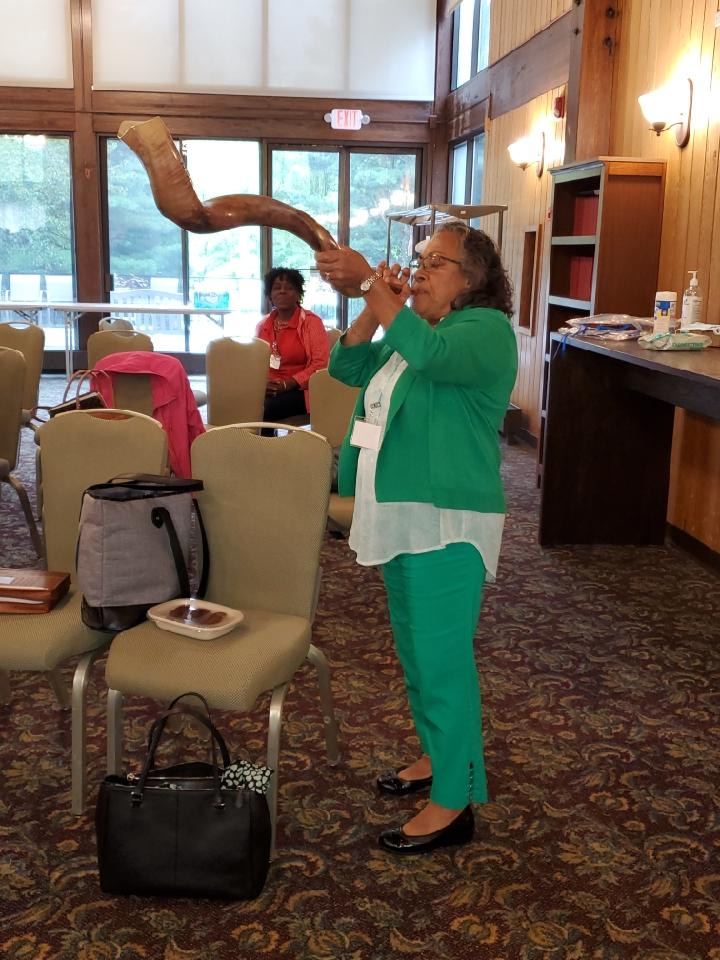 Former Board Member Maria Coenraad blowing the shofar